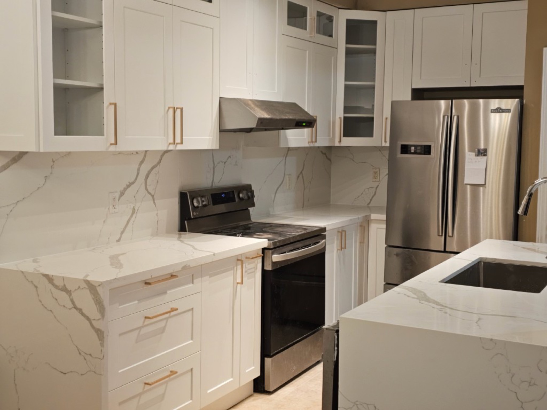Full-height stone backsplash with custom cabinets