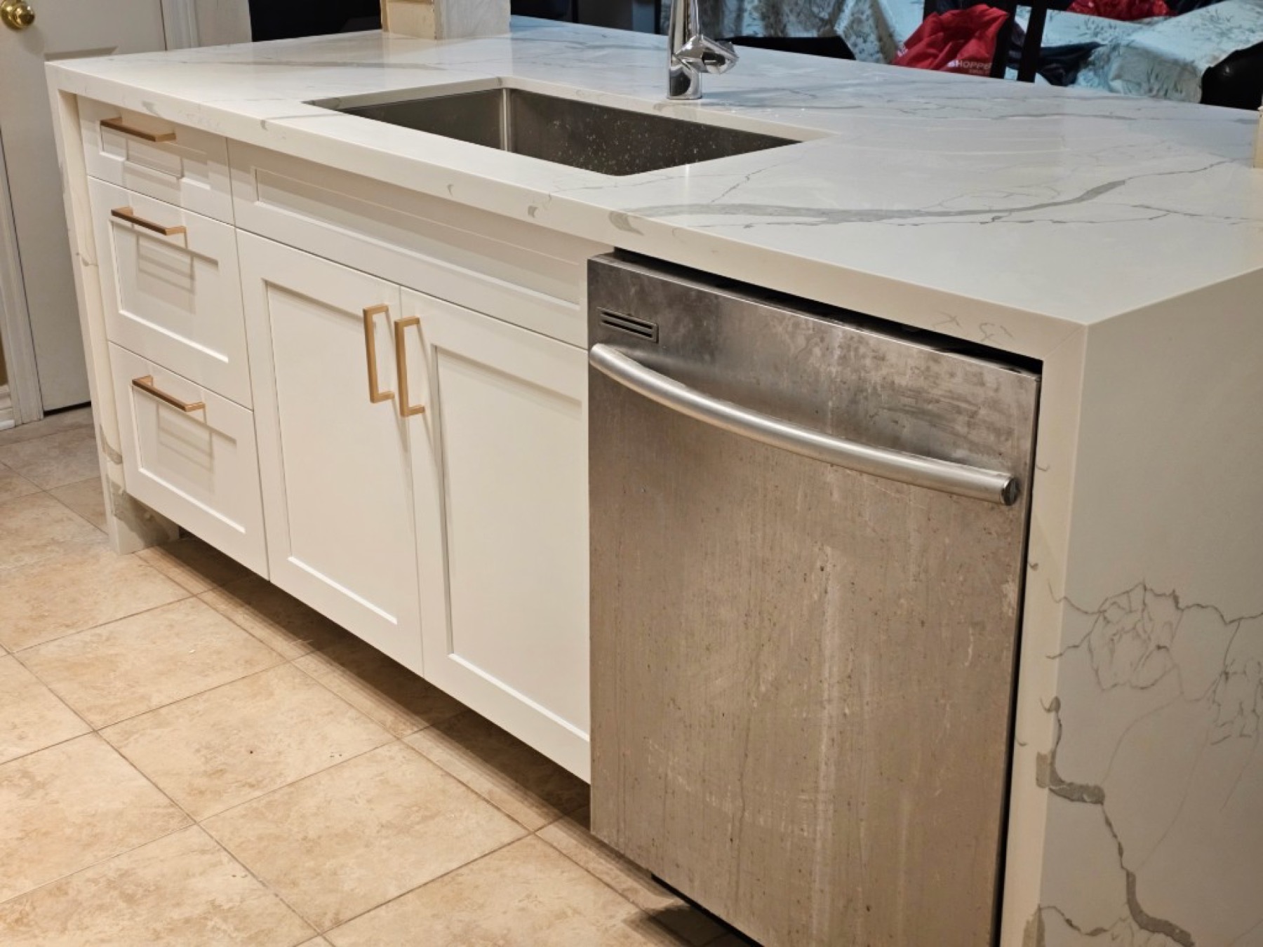 Island sink, dishwasher, and gold hardware